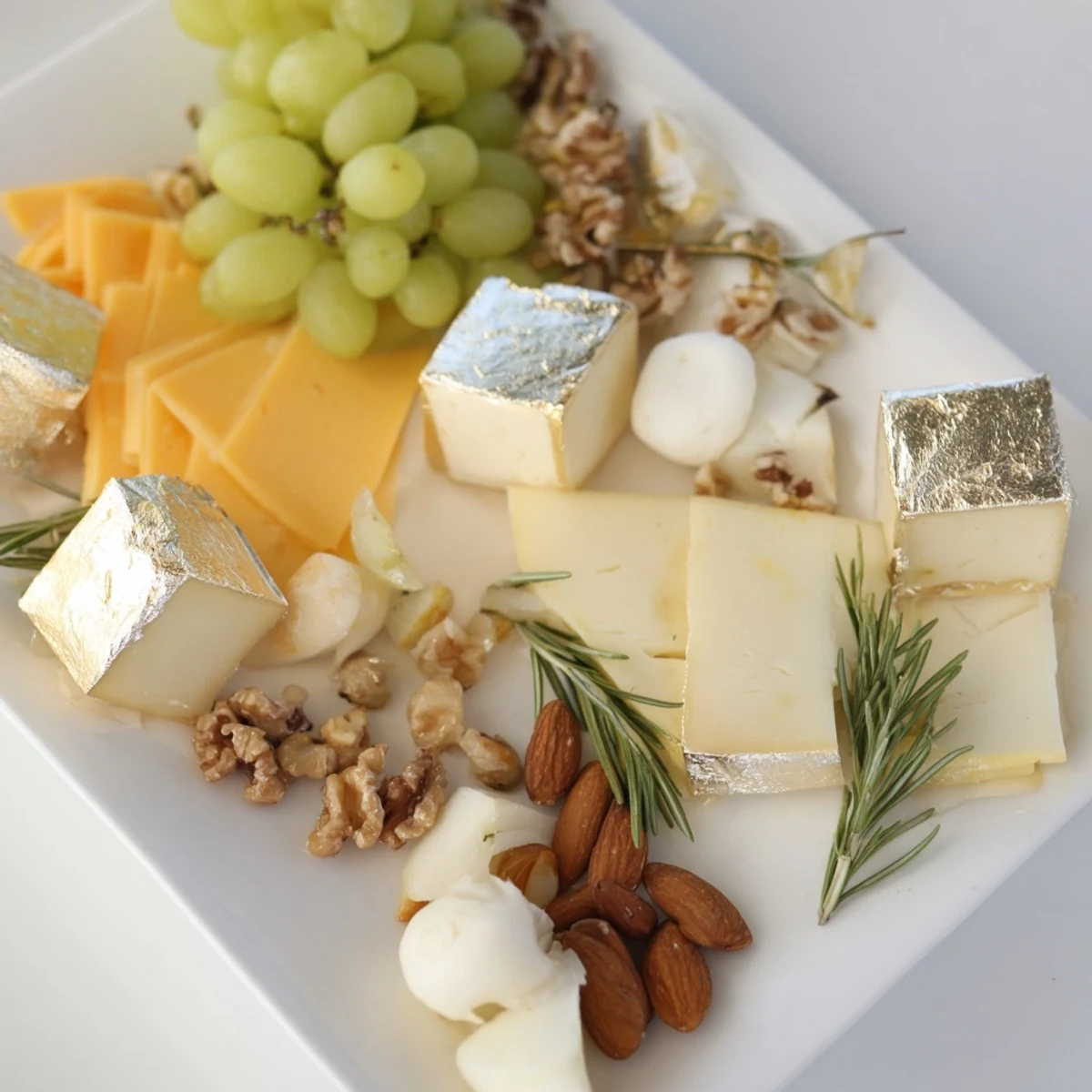 Elegant Gold and Silver Cheese Cube Board: showcasing a variety of cheeses, fruit and nuts for guests.