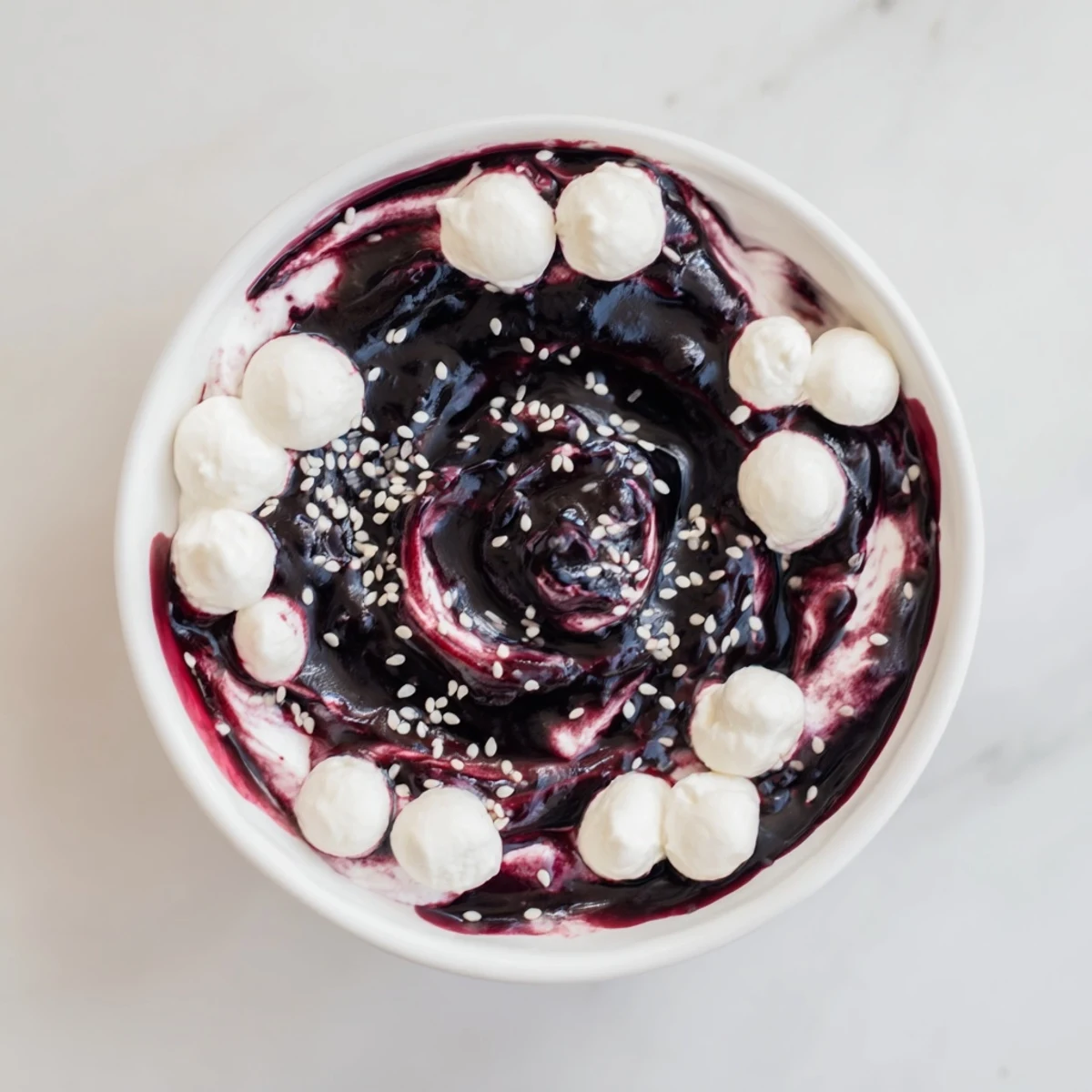 This elegant The Galaxy Spiral dessert features starry goat cheese and a stunning berry jam spiral for serving.