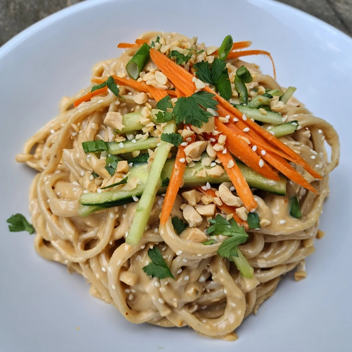 Bowls of cold sesame noodles topped with fresh cilantro, inviting you to eat.