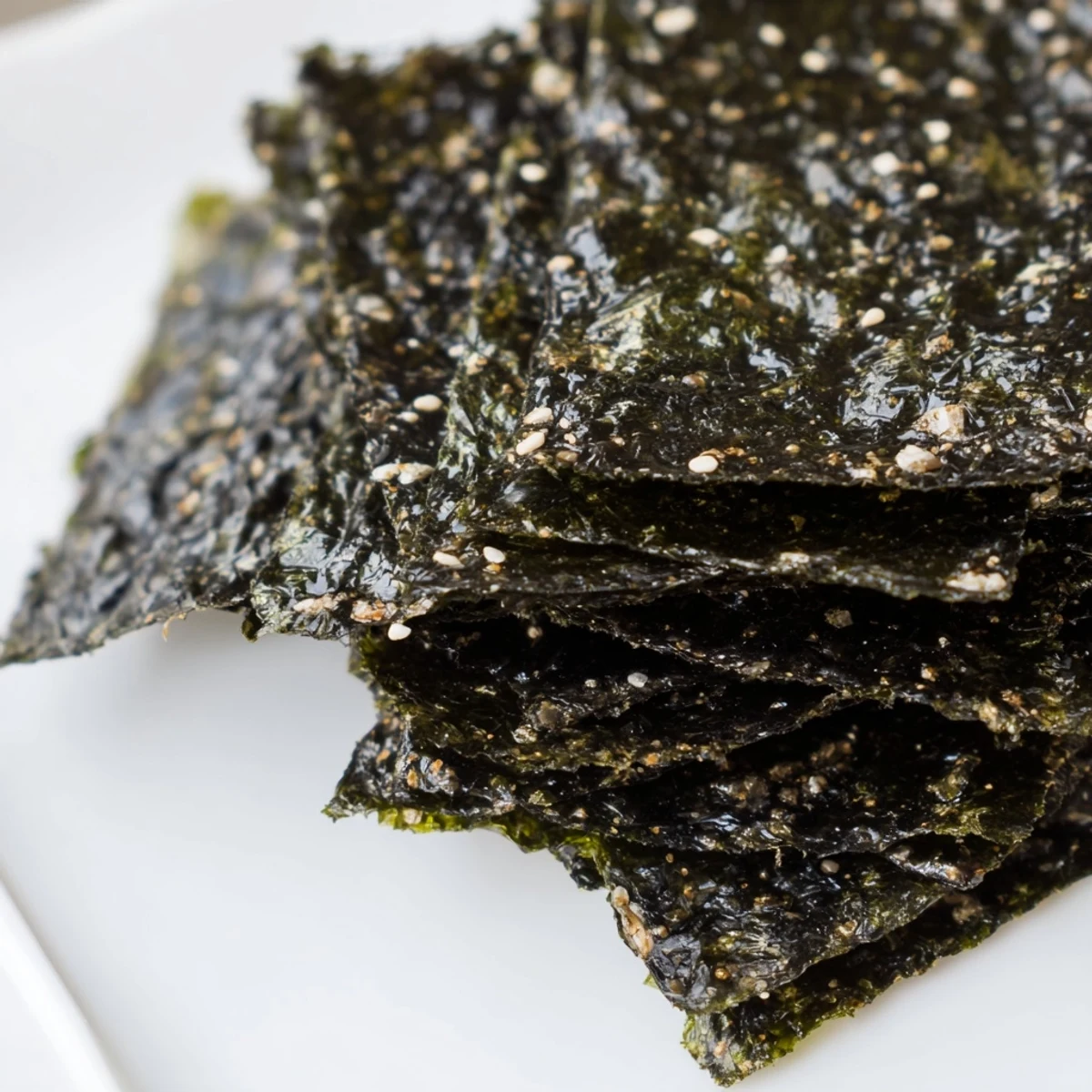 Light, savory roasted seaweed chips cooling on a sheet, perfect for dipping or topping.