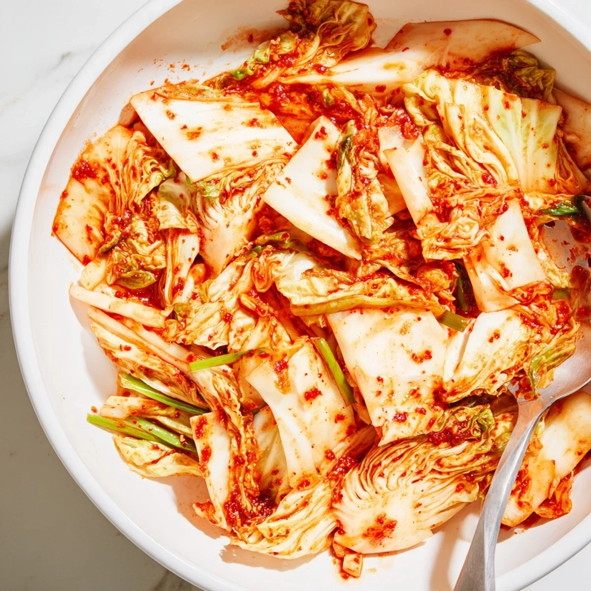 Vegan kimchi served alongside steamed rice and fried eggs highlights the tangy, probiotic-rich Korean side dish with vibrant colors and crunch.
