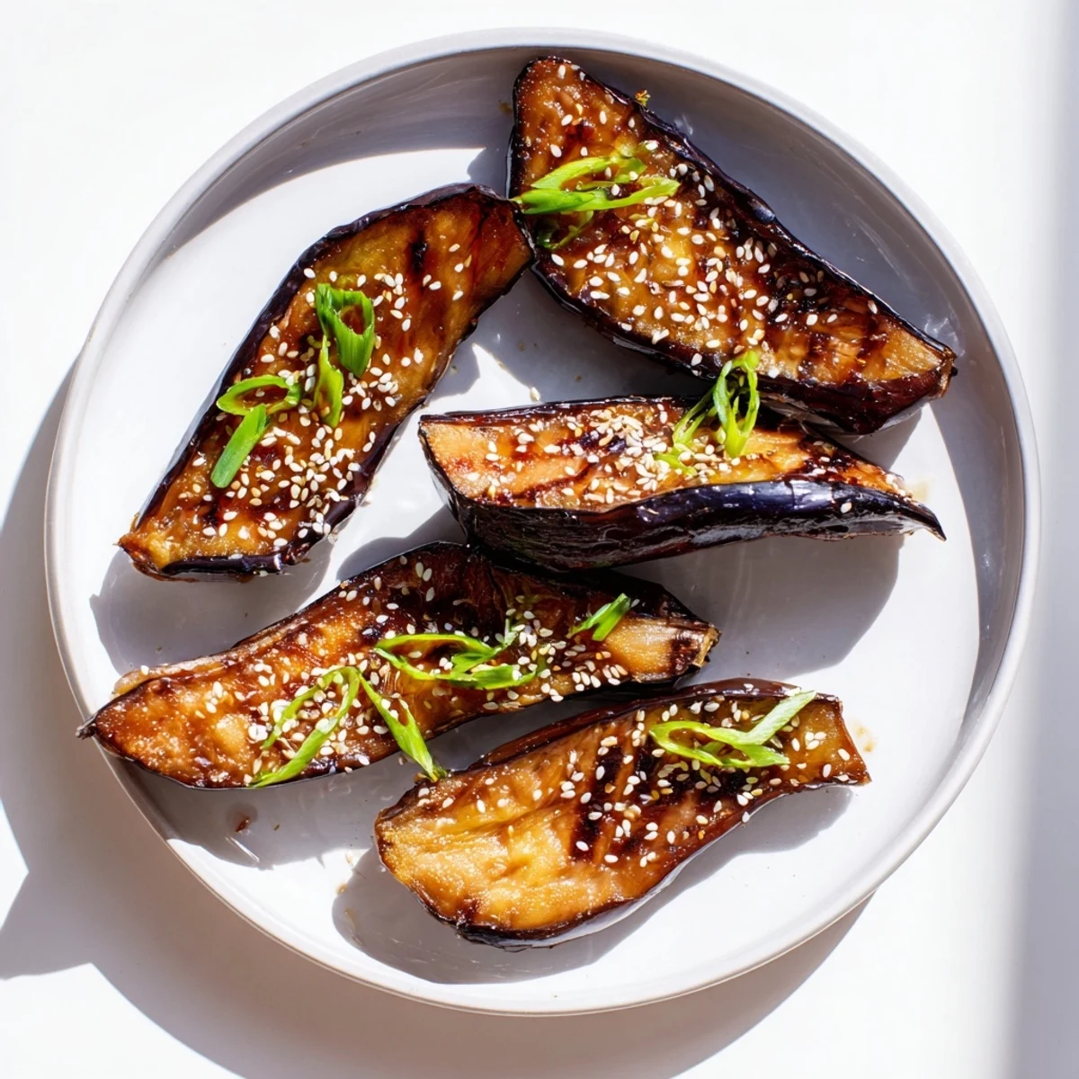 Perfectly cooked Japanese eggplant with a rich, sweet-savory Miso Glazed Eggplant garnished with fresh green onions.  