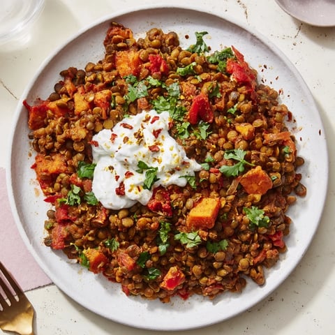 Warm and hearty Wheat-Warm Hearty Lentil Curry simmering with carrots and rich spices in a pot.