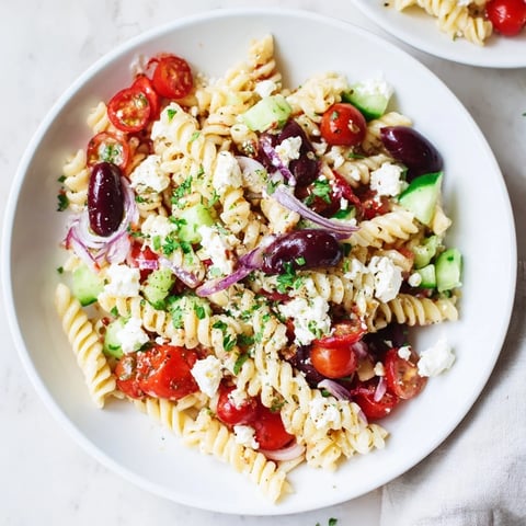 Mediterranean Olive Oil and Feta Pasta Salad, colorful with tomatoes, olives, and creamy feta.