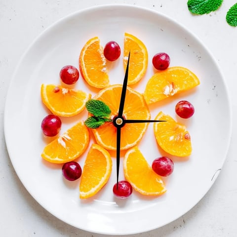 Juicy orange slices and sweet grapes create a cheerful Grape and Orange Slice Clock Face for brunch.