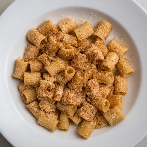 Golden brown Air Fryer Pasta Croutons, perfectly crunchy, ready to top a fresh green salad or enjoy as a snack.
