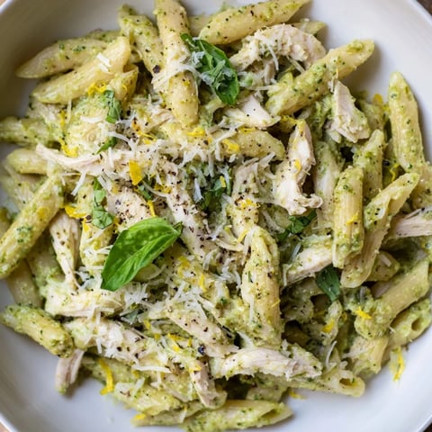 Tender 10-Minute Pesto Pasta with Chicken, garnished with basil, ready for a quick weeknight dinner.