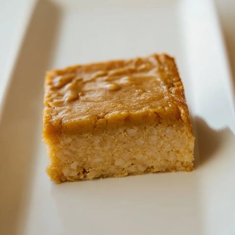 Warm and golden Peanut Butter Mochi Cake, a dessert with a tender, chewy texture, ready to serve.