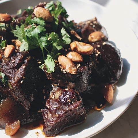 Moroccan lamb tagine with prunes and almonds, a hearty stew with tender lamb and sweet prunes.