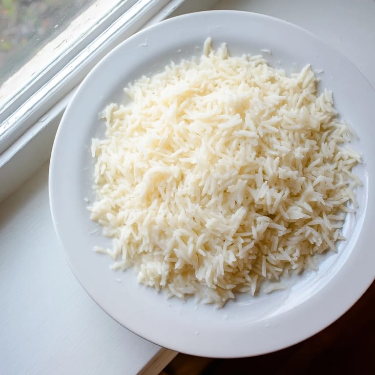 Creamy Coconut Jasmine Rice with fluffy grains, ideal for serving alongside a vibrant Thai curry.