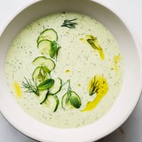 Creamy chilled cucumber garlic soup garnished with fresh dill, ready to eat on a hot day.