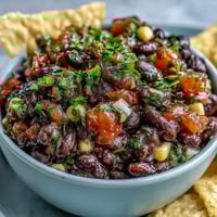 Creamy 3-Ingredient Cowboy Caviar Dip with black beans, sweet corn, and fresh pico de gallo served with crispy tortilla chips.  