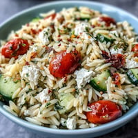 Vibrantly fresh orzo salad with cucumber, feta, and lemon dressing, ready to serve.